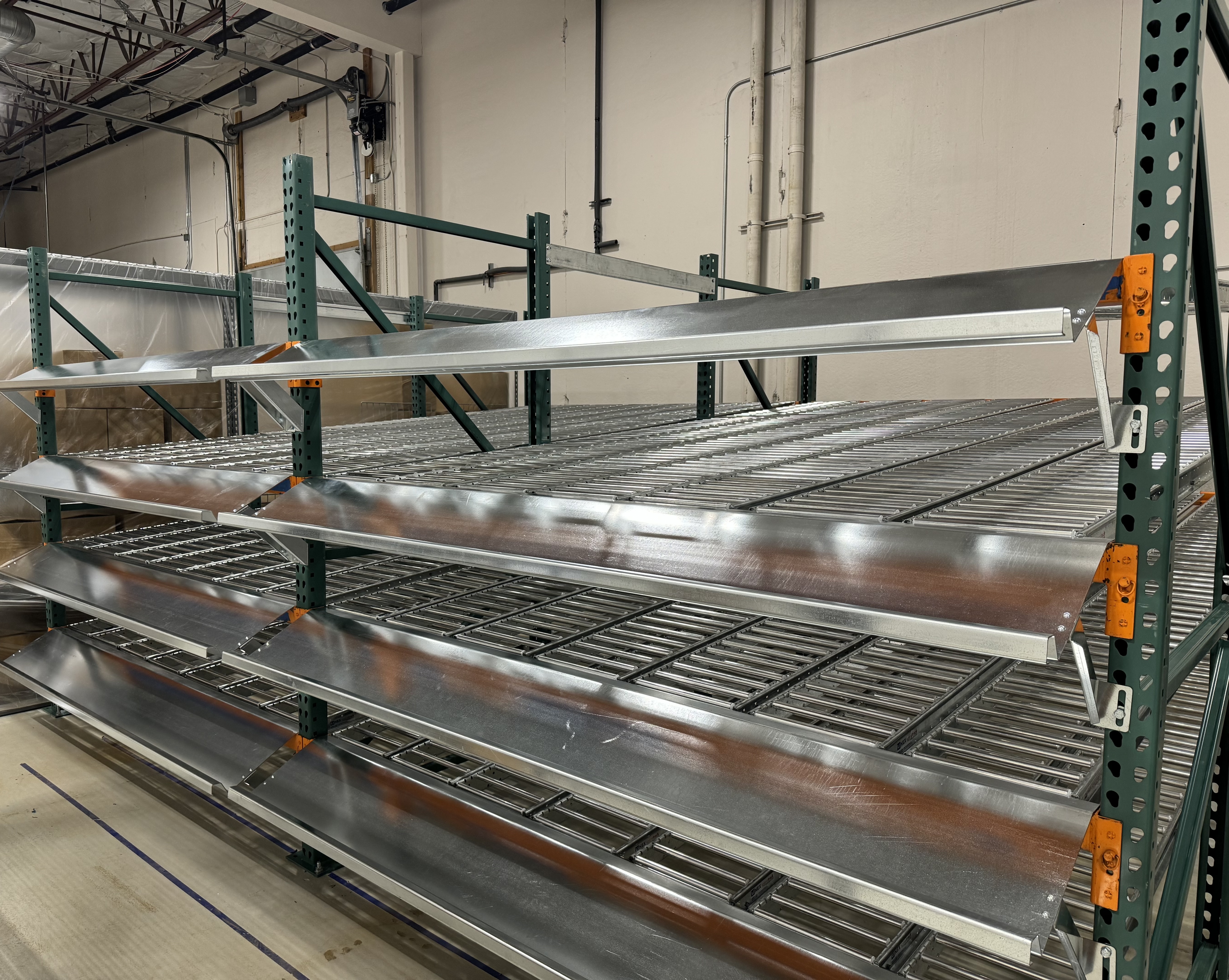 2 short but deep bays of pallet flow racking, 4 levels each.